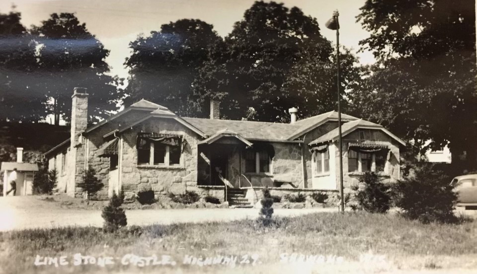 Vintage postcard photograph captioned Lime Stone Castle, Highway 29, Shawano, Wisconsin — a low stone building among trees