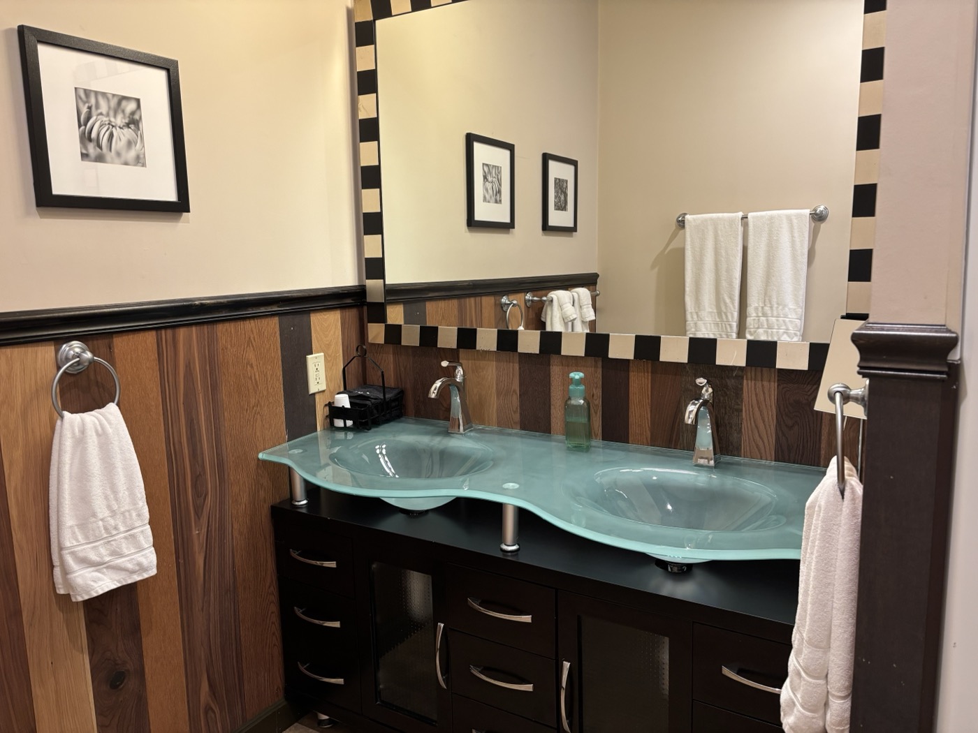 The third bathroom &mdash; double glass vessel sinks under a checkered mirror