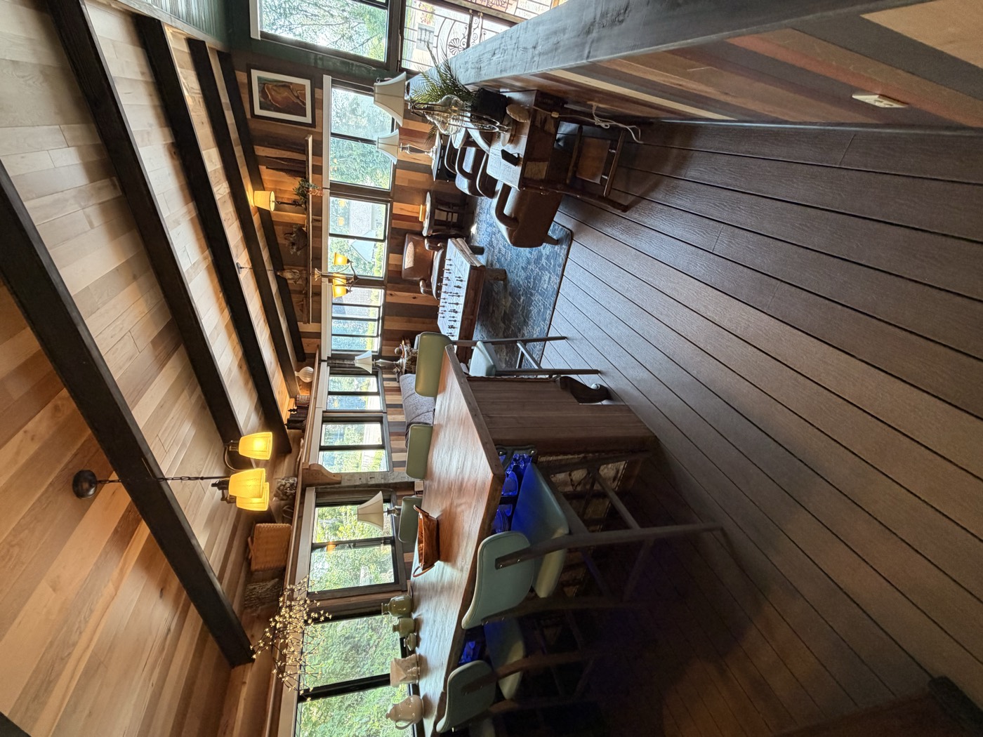 The enclosed summer kitchen seating area with windows and exposed beams