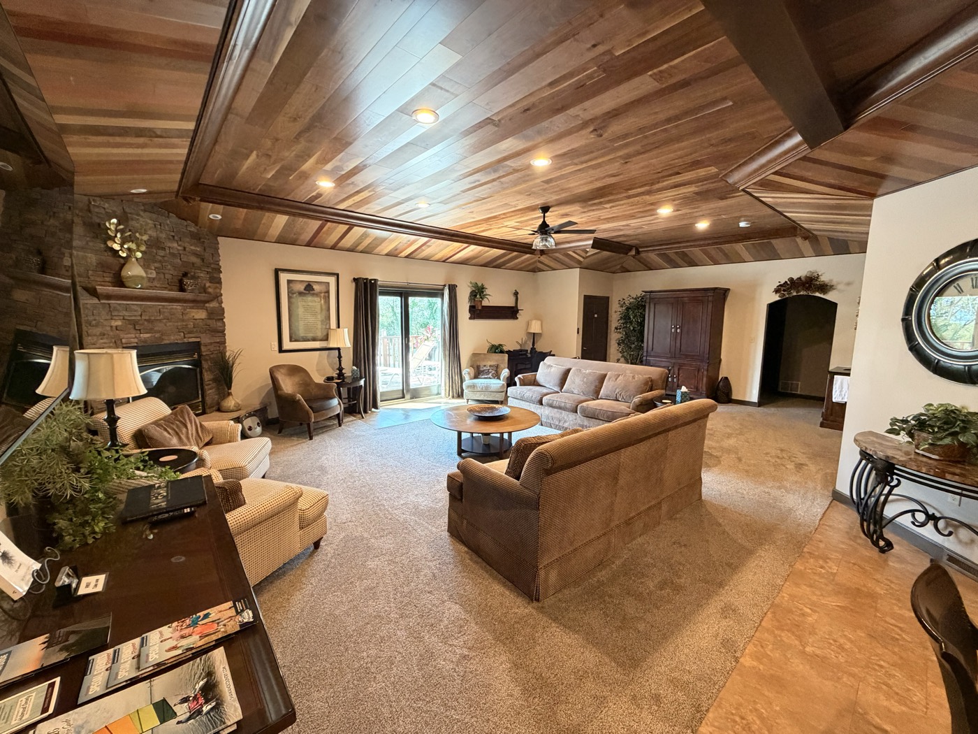 The great room, with a Black Walnut ceiling, exposed beams and several seating areas