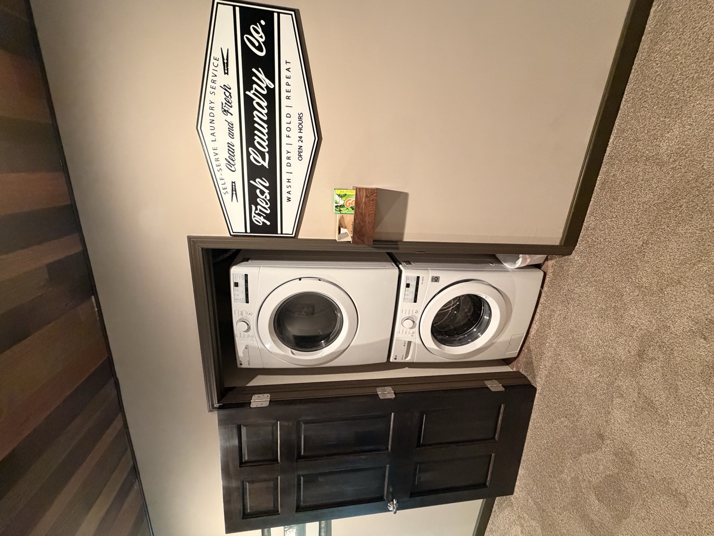 A laundry room with a stacked washer and dryer